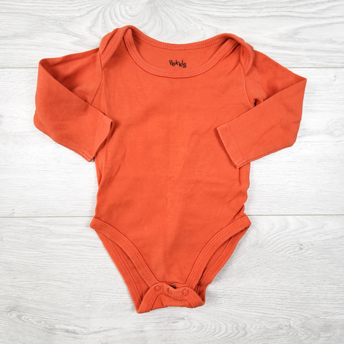 Pekkle orange long sleeved bodysuit. Size 3 months