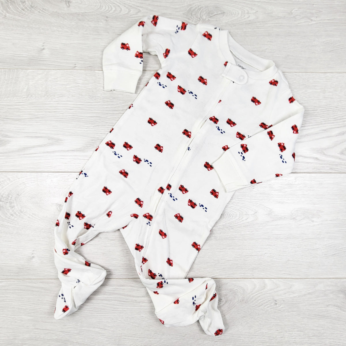 Carters white zippered cotton sleeper with fire trucks. Size 9 months
