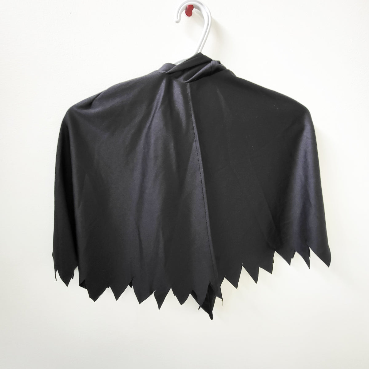 Spirit Halloween black hooded cape. Size medium