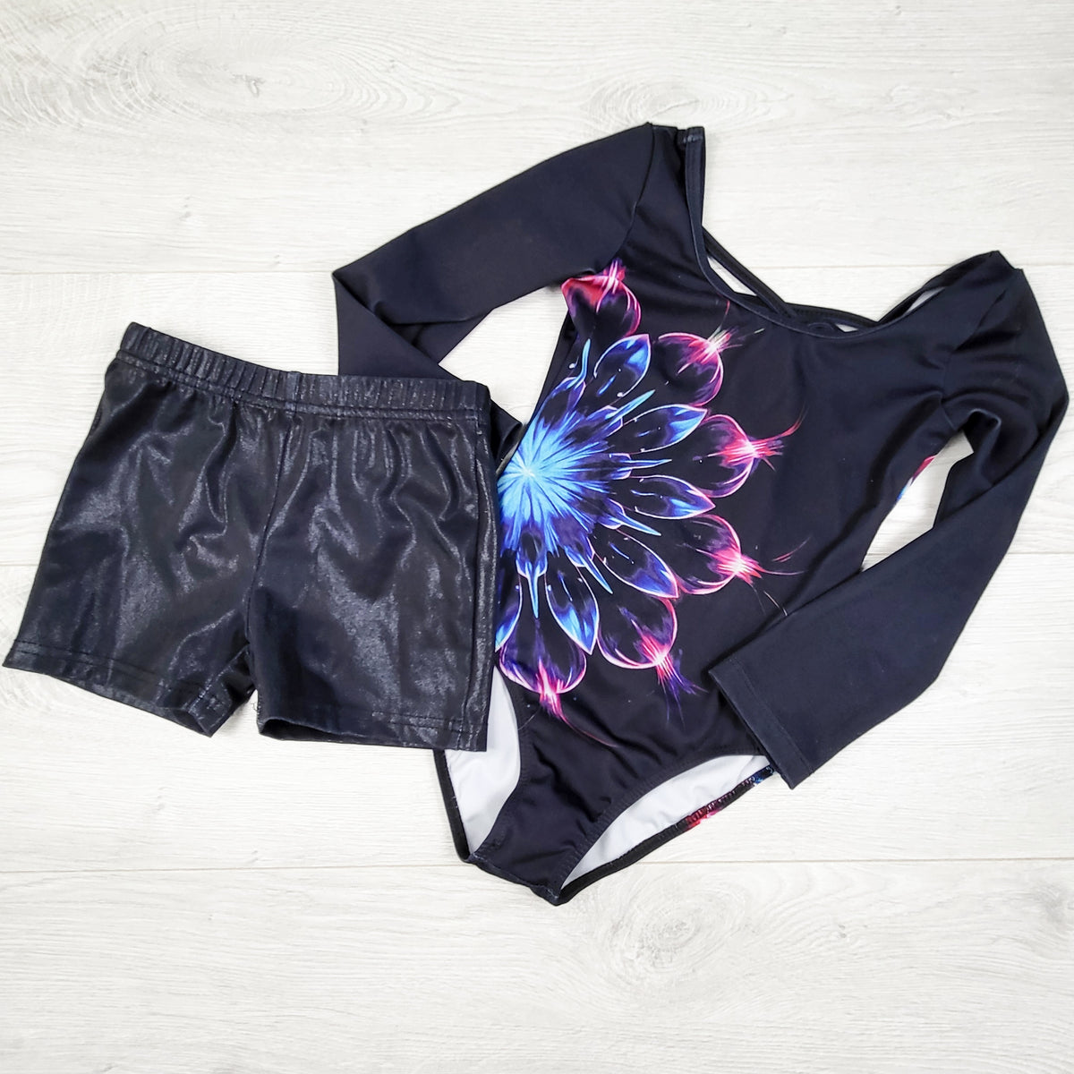 Black gymnastics bodysuit with matching shorts. Size 5/6