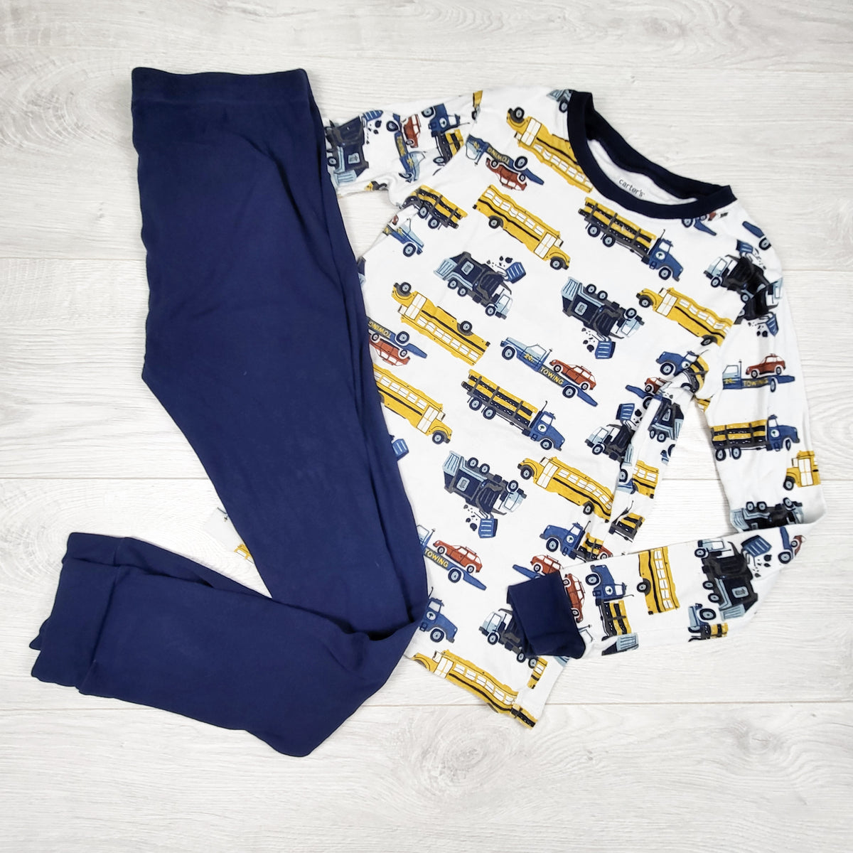 Carters white and navy 2pc PJs with vehicles. Size 12- AS IS